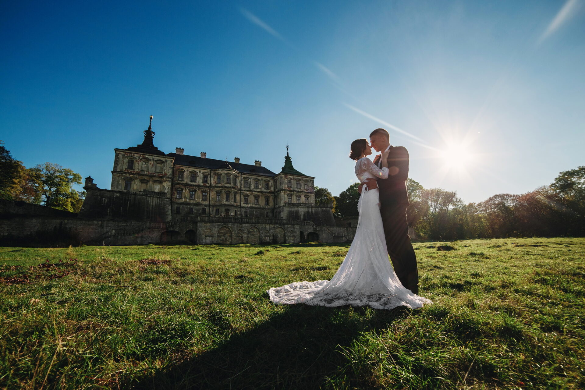 Beau couple de mariage marchant au soleil près du vieux château. 